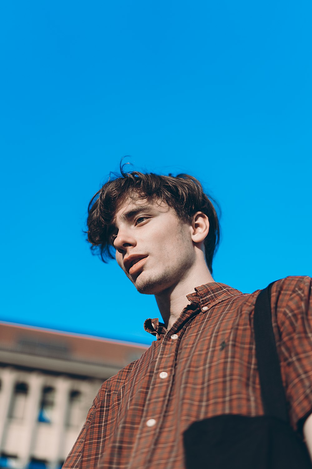 low angle photo of man beside building