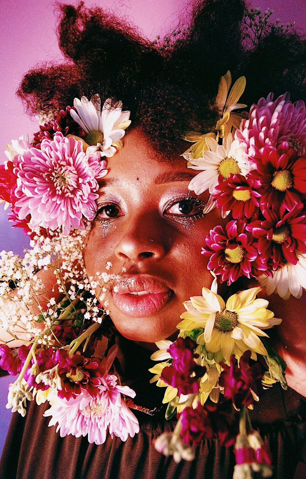 woman's face covered by flowers