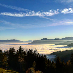 Panoramic view of Mount Merbabu’s peak with clouds rolling below.