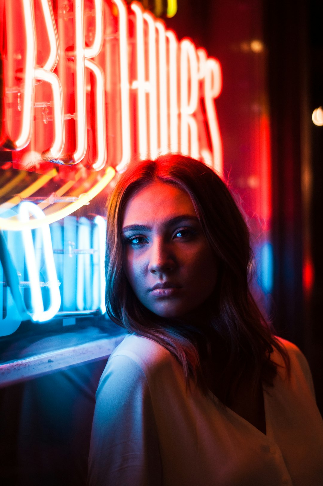 woman near red LED sign