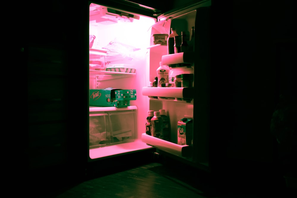 opened refrigerator filled with bottles