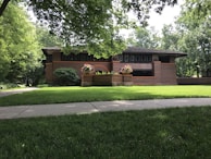 A completed domestic building project showcasing sturdy brickwork and a welcoming front porch.