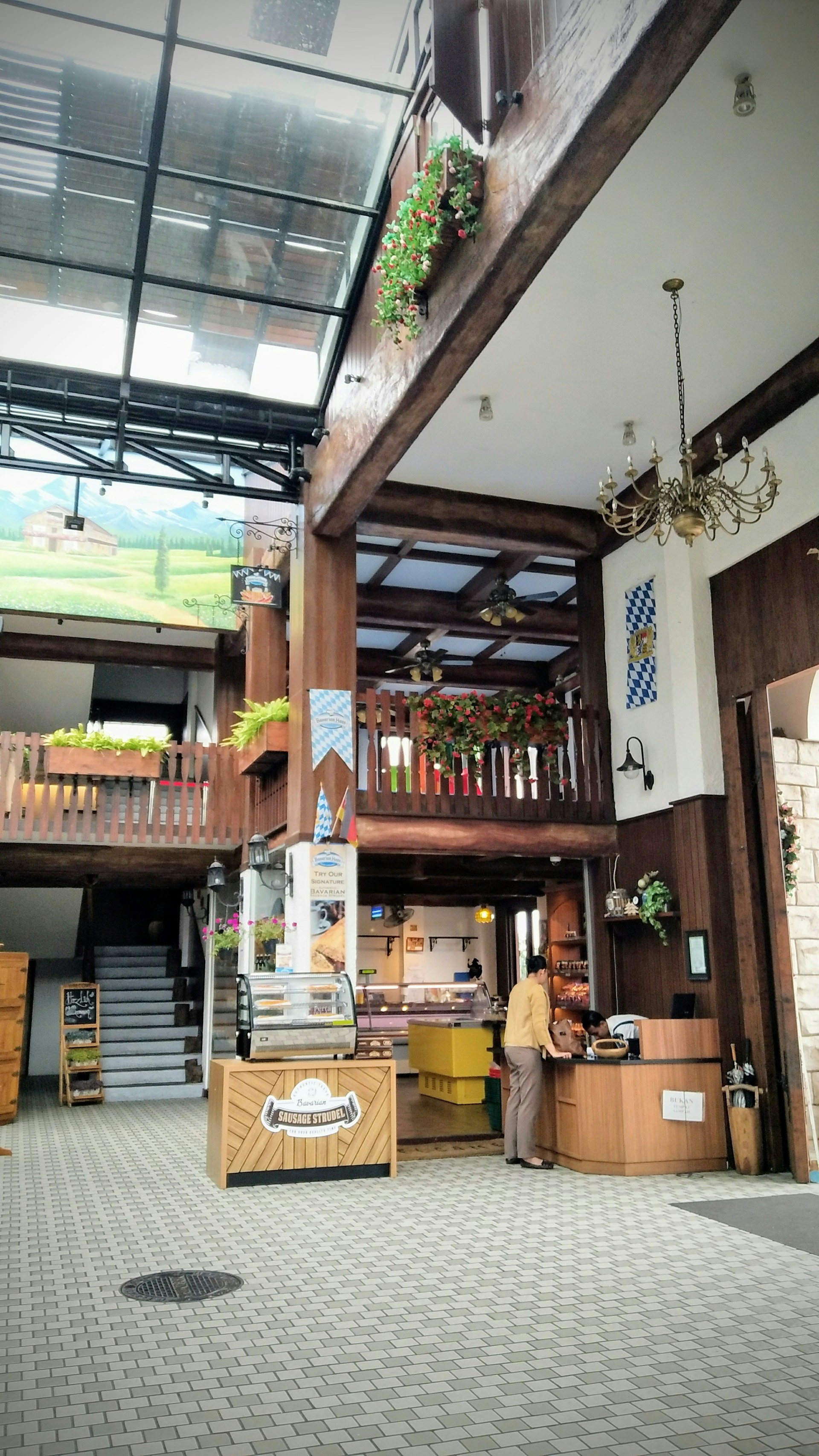 A cozy Bavarian restaurant interior with traditional blue and white decor and wooden tables set for guests.