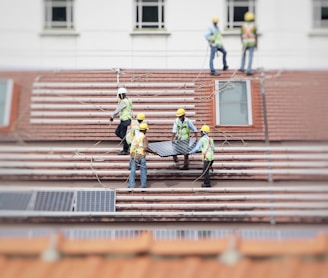 man holding solar panel on roof