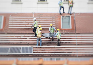 man holding solar panel on roof