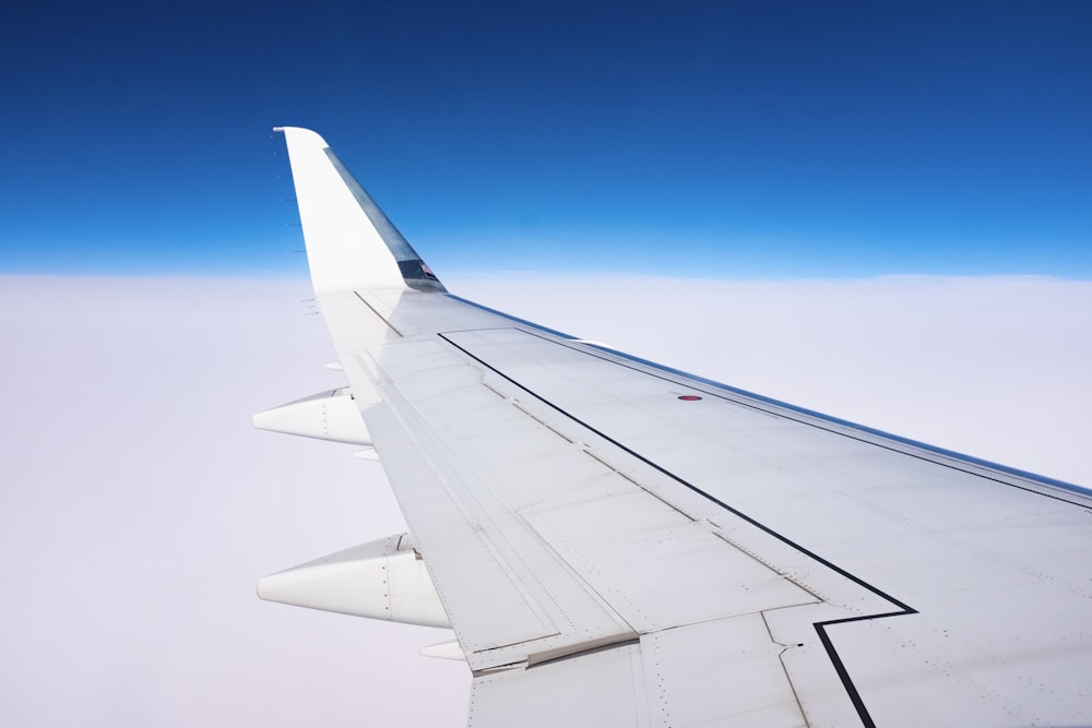 a view of the wing of an airplane in the sky