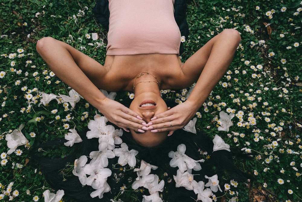 woman lying on flower field