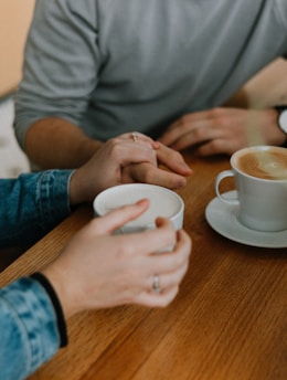 two mugs with coffee on table