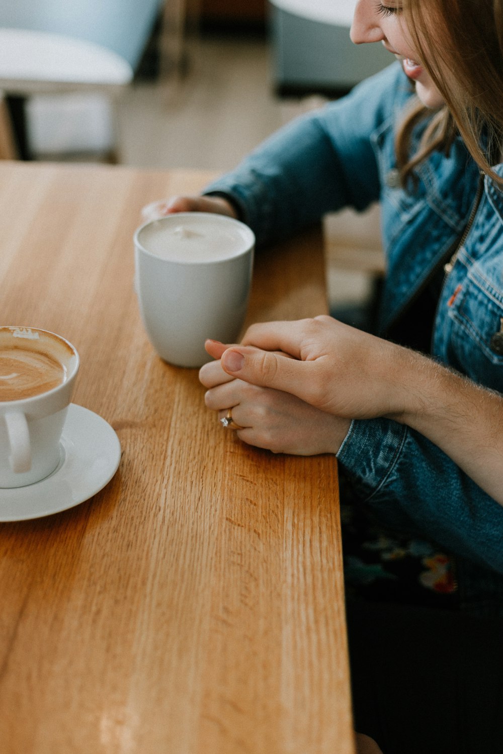 woman taking coffee on brown table