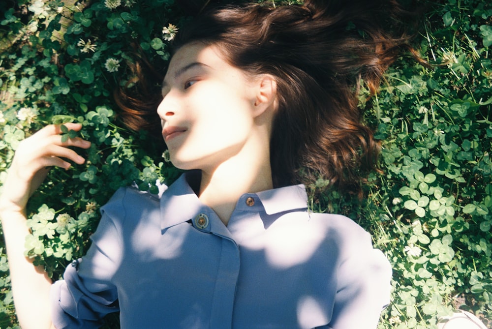 woman lying on grass field