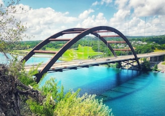 concrete bridge above calm body of water