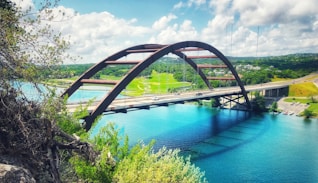 concrete bridge above calm body of water