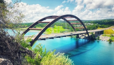 concrete bridge above calm body of water capital building google meet background