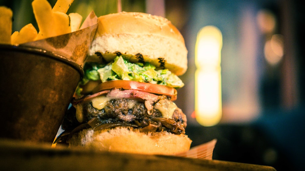 hamburger with lettuce, cheese, tomato, and ham