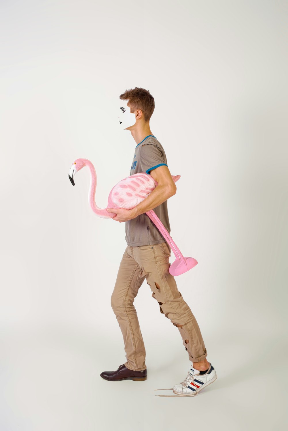 man carrying flamingo ornament illustration
