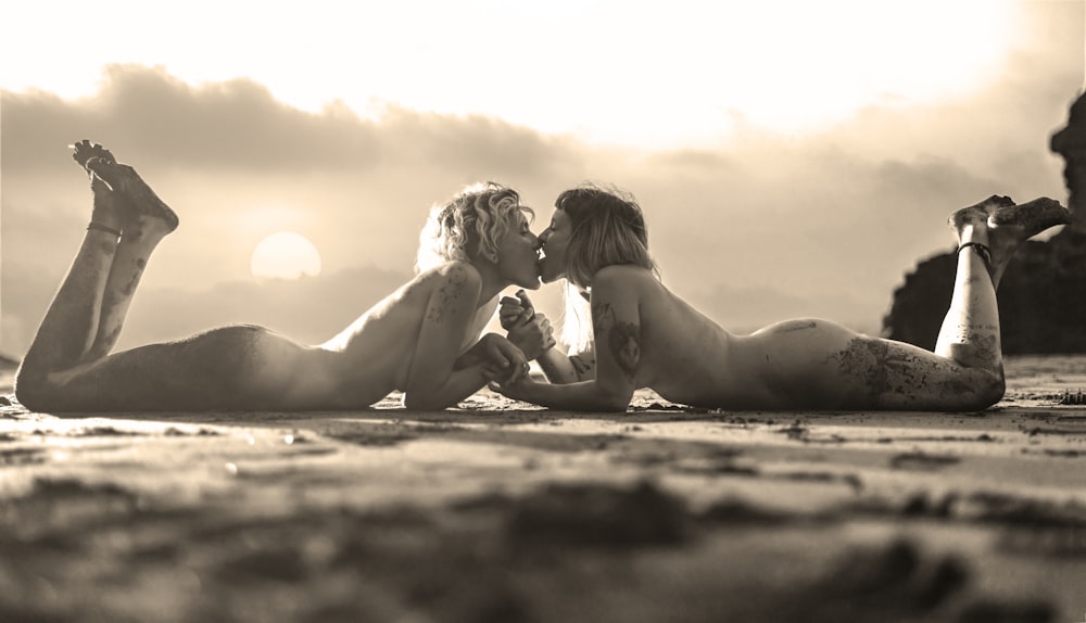 couple kissing lying on the seashore photography