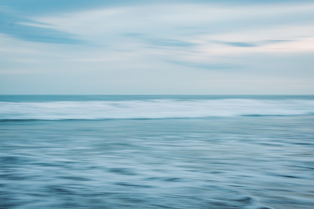 calm body of water under blue sky