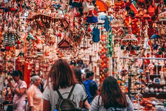 A vibrant market scene filled with colorful festival decorations and joyful people celebrating together.
