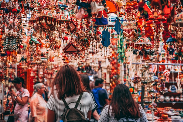 A vibrant market scene filled with colorful festival decorations and joyful people celebrating together.