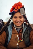 woman wearing brown cardigan with flower on head