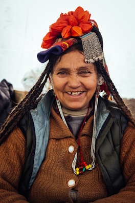 woman wearing brown cardigan with flower on head