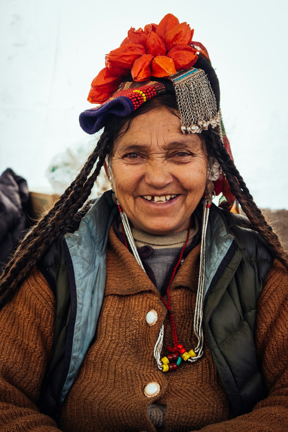 woman wearing brown cardigan with flower on head