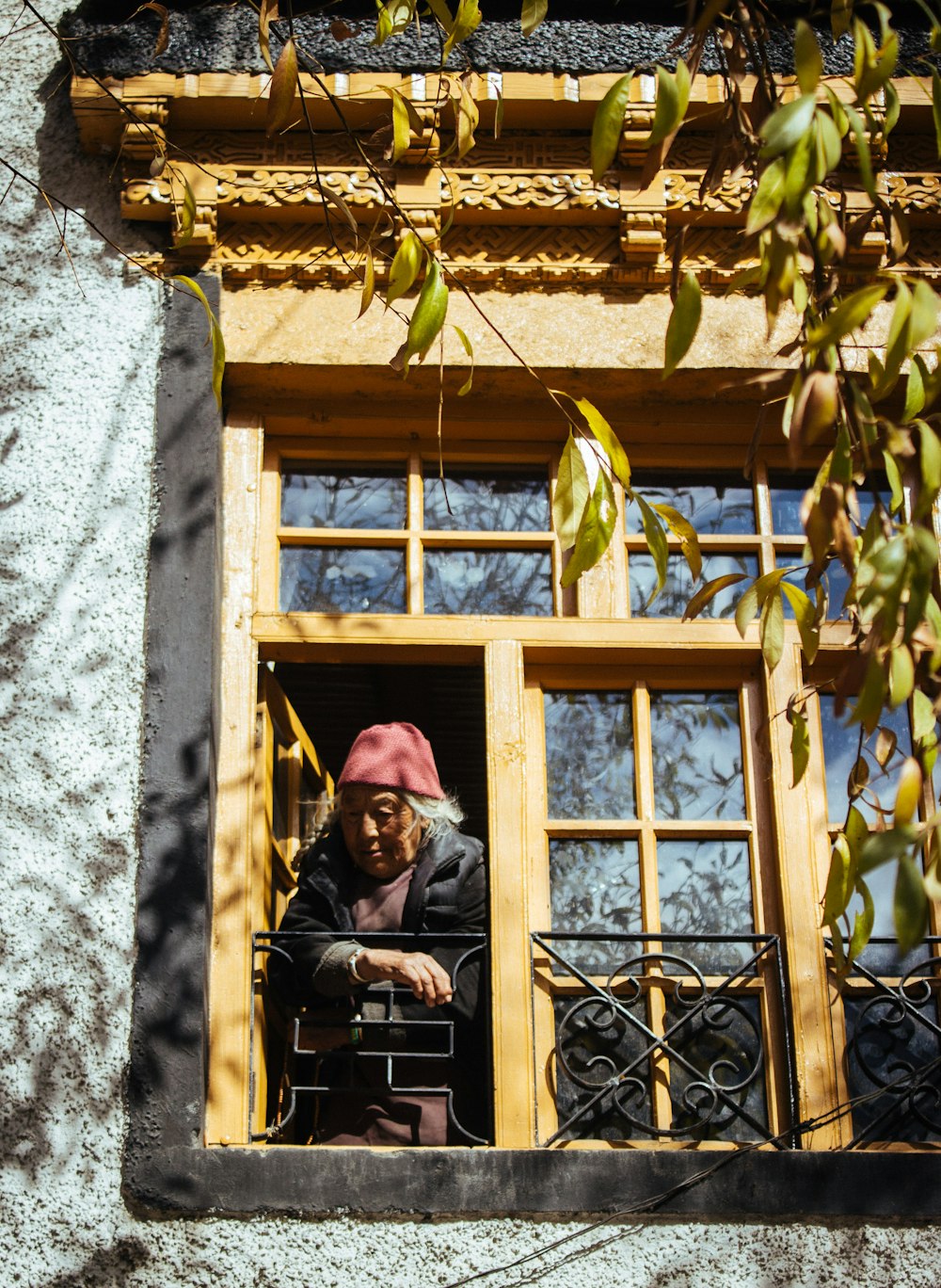 woman standing open window