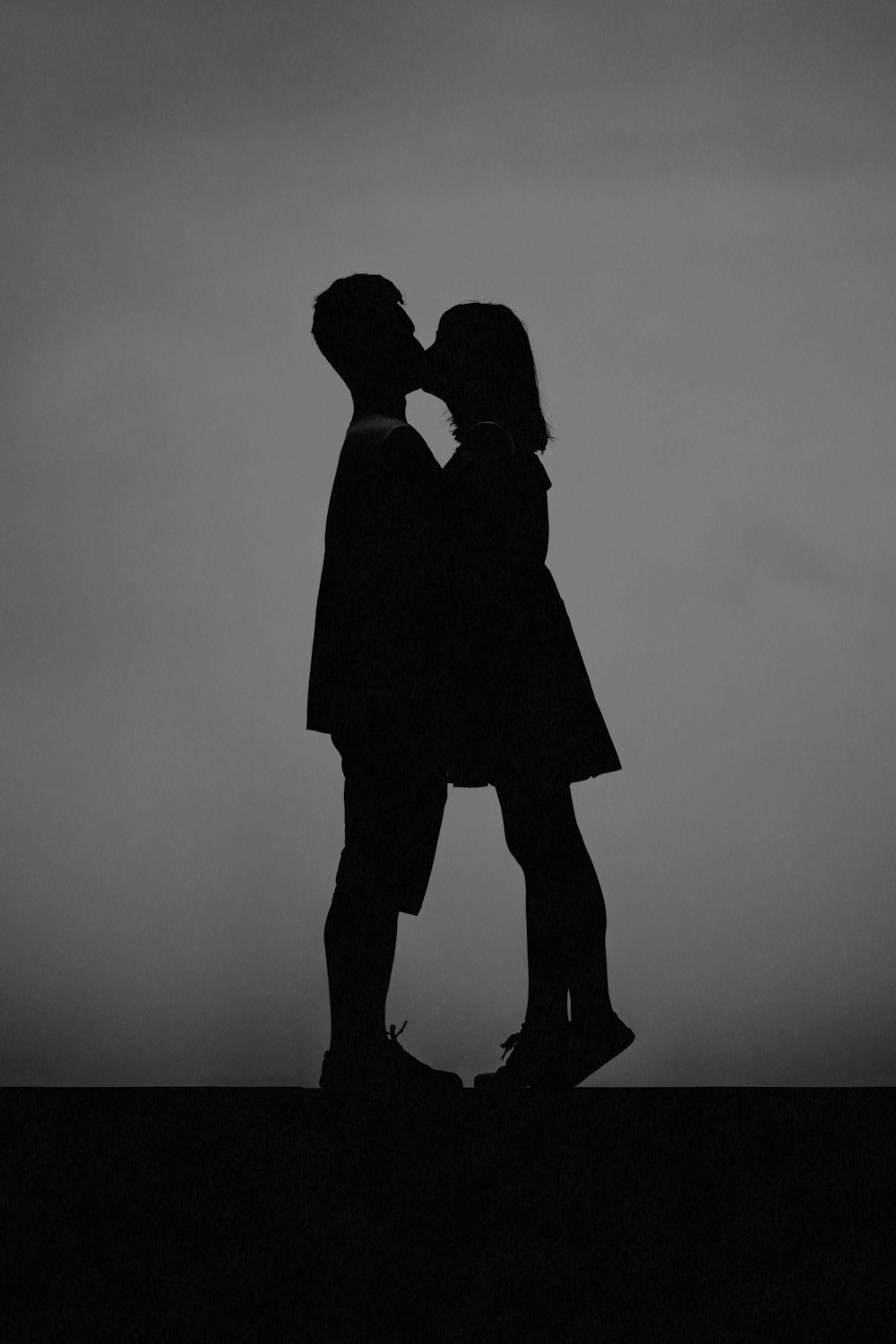 man and woman kissing each other
