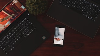powered-on Android smartphone near two laptops