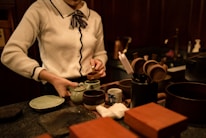 Close-up of hands preparing a traditional tea ceremony