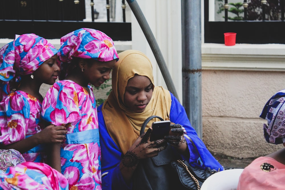 three girls looking at smartphone