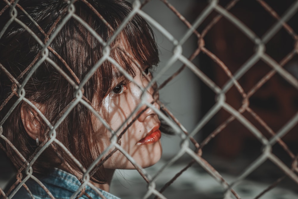 woman leaning on gray gate