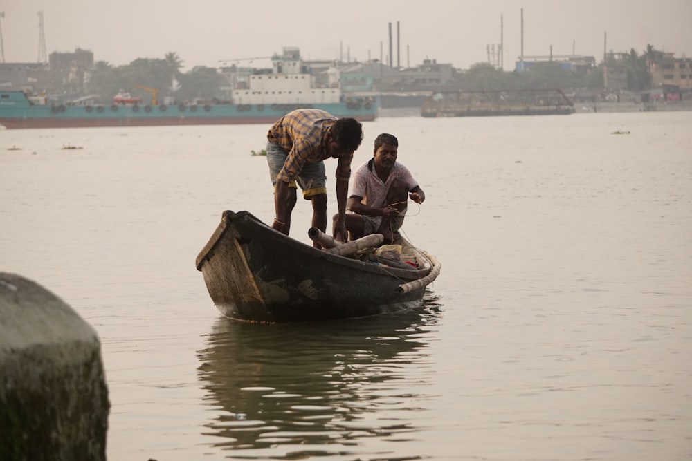 two man in gray boat