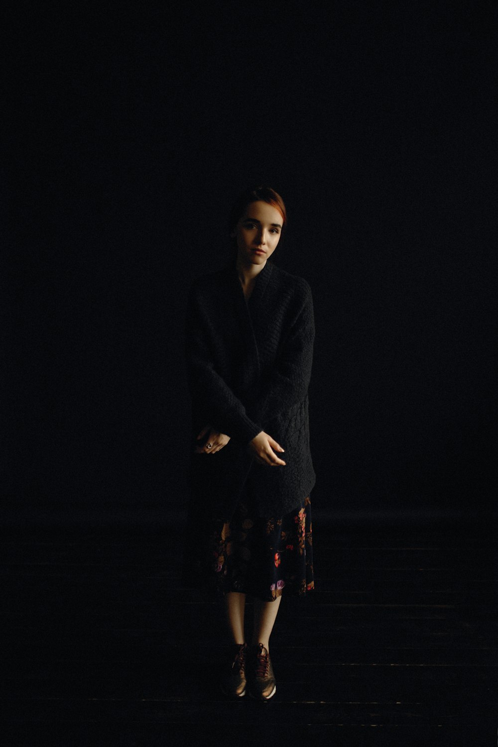 woman wearing black cardigan and skirt