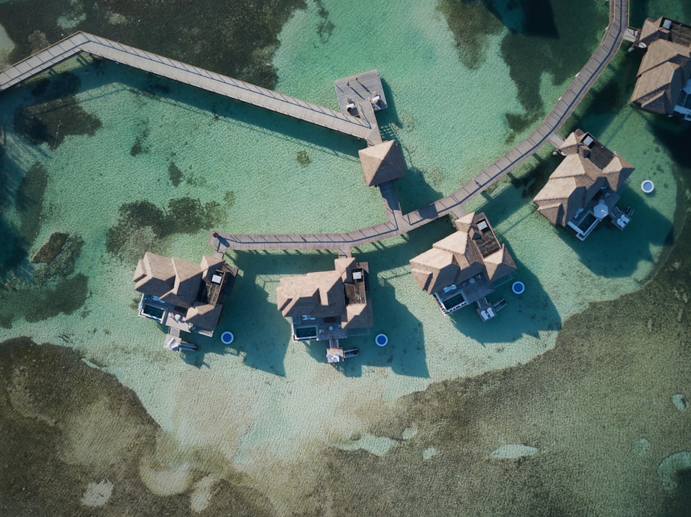 a bird's eye view of a group of huts in the water