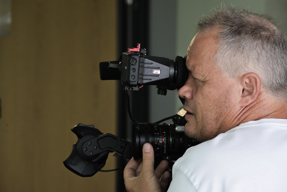 man wearing white shirt taking photo