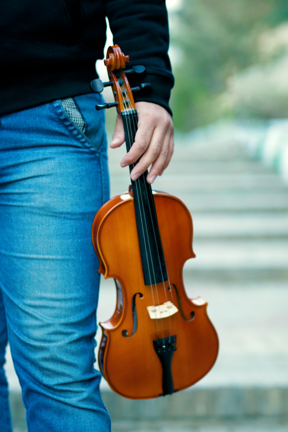 man holding brown violin