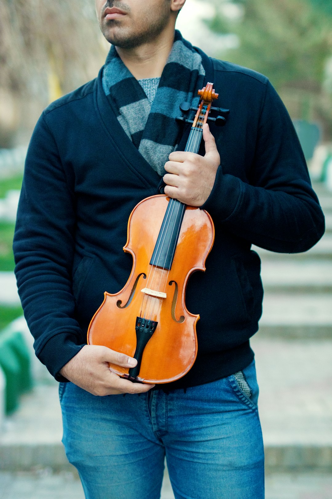 man holding brown violin