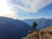 man on top of mountain under blue sky