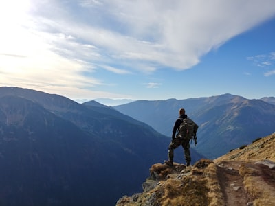 man on top of mountain under blue sky adventure google meet background