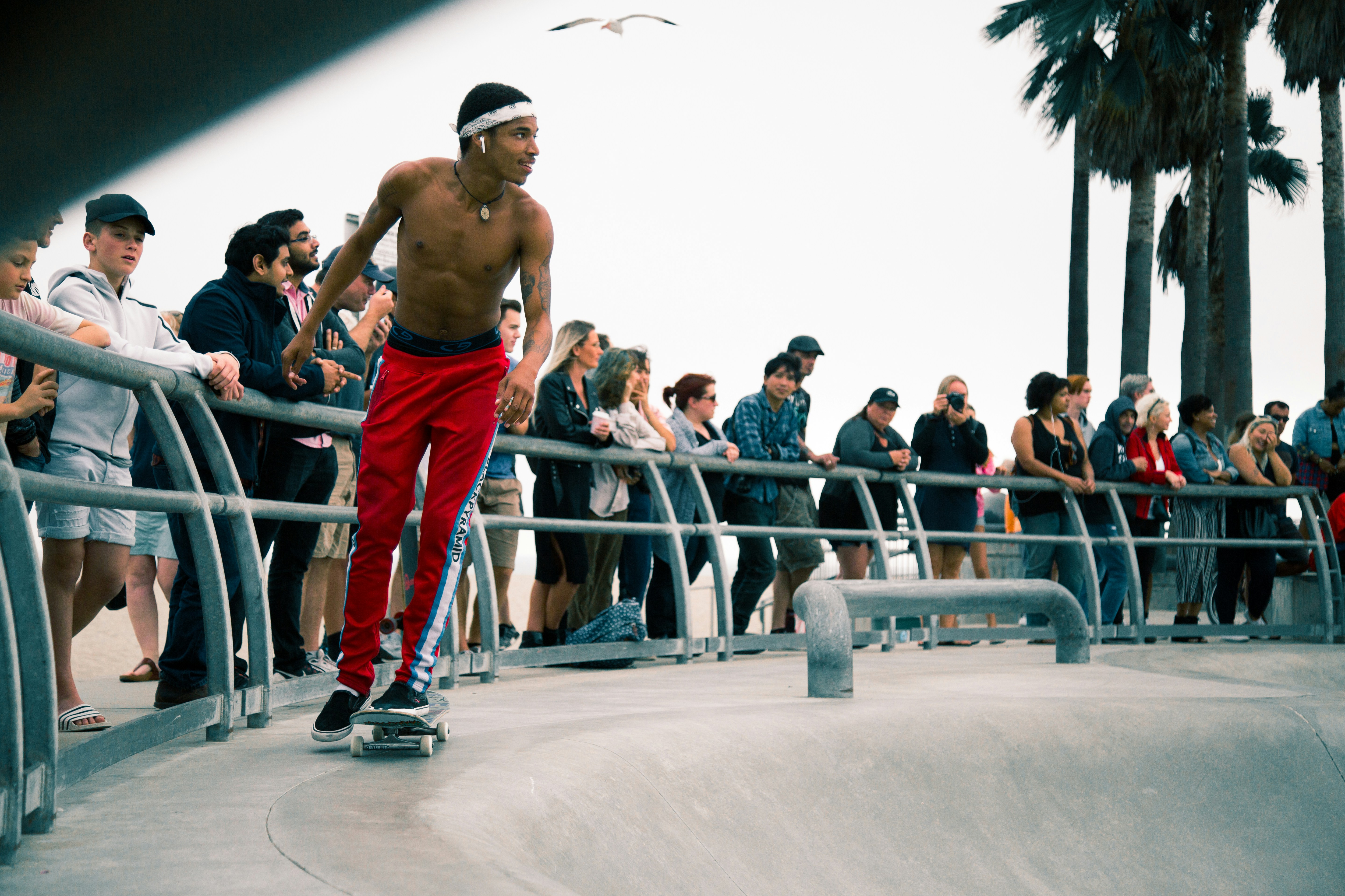 man skateboarding infront of people