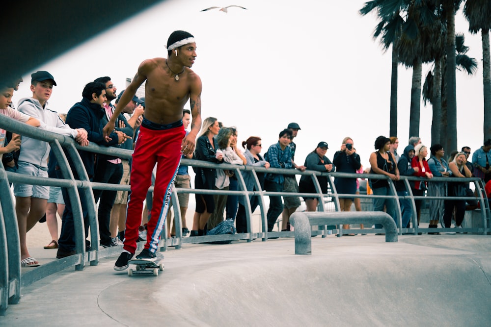 man skateboarding infront of people