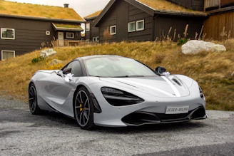 gray sports coupe parking during daytime