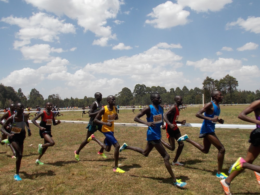 group of men running on field