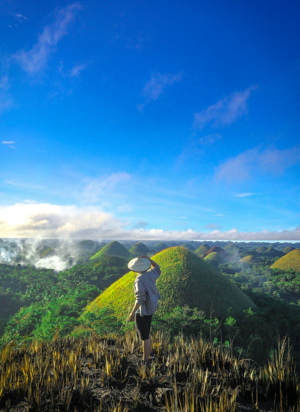 man wearing white shirt with view of hills