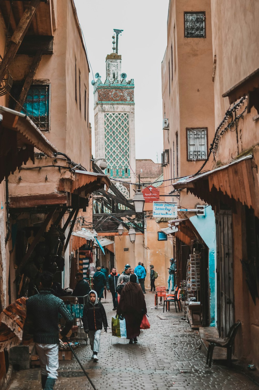 people walking on sidewalk beside market