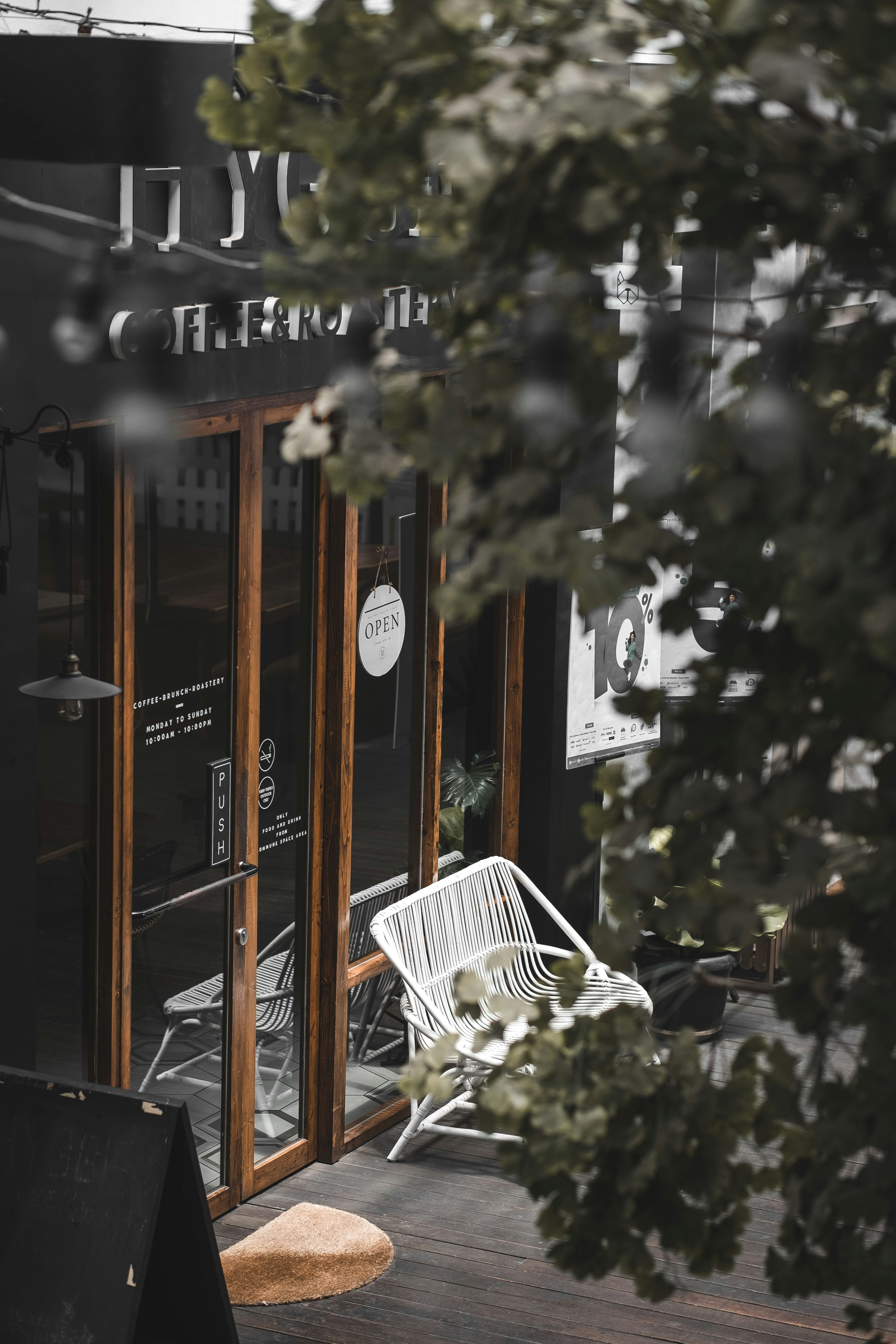 empty white metal framed bench outside glass walla