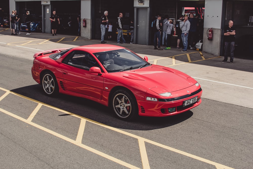 red sports coupe on road