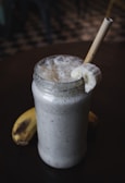 A close-up of a creamy banana smoothie in a glass.