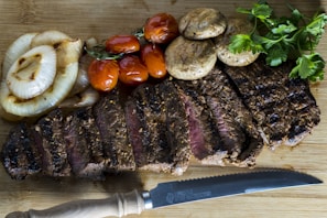 Fresh arrachera steaks beautifully seasoned on a rustic wooden board.
